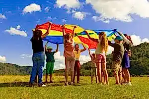 group of women standing on green grass field during daytime