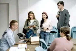 A diverse group of college students engaging in a lively study session indoors.